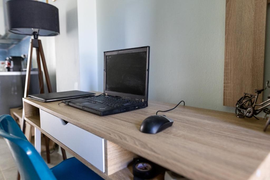 A work desk with the guest laptop, beside the kitchen