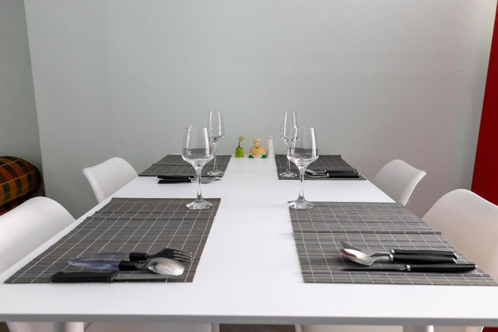The dining table laid for four, with the living area behind